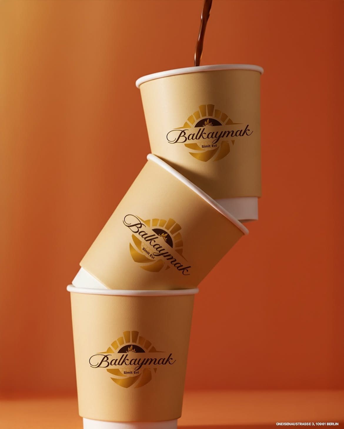 Stacked Balkaymak coffee cups with coffee pouring