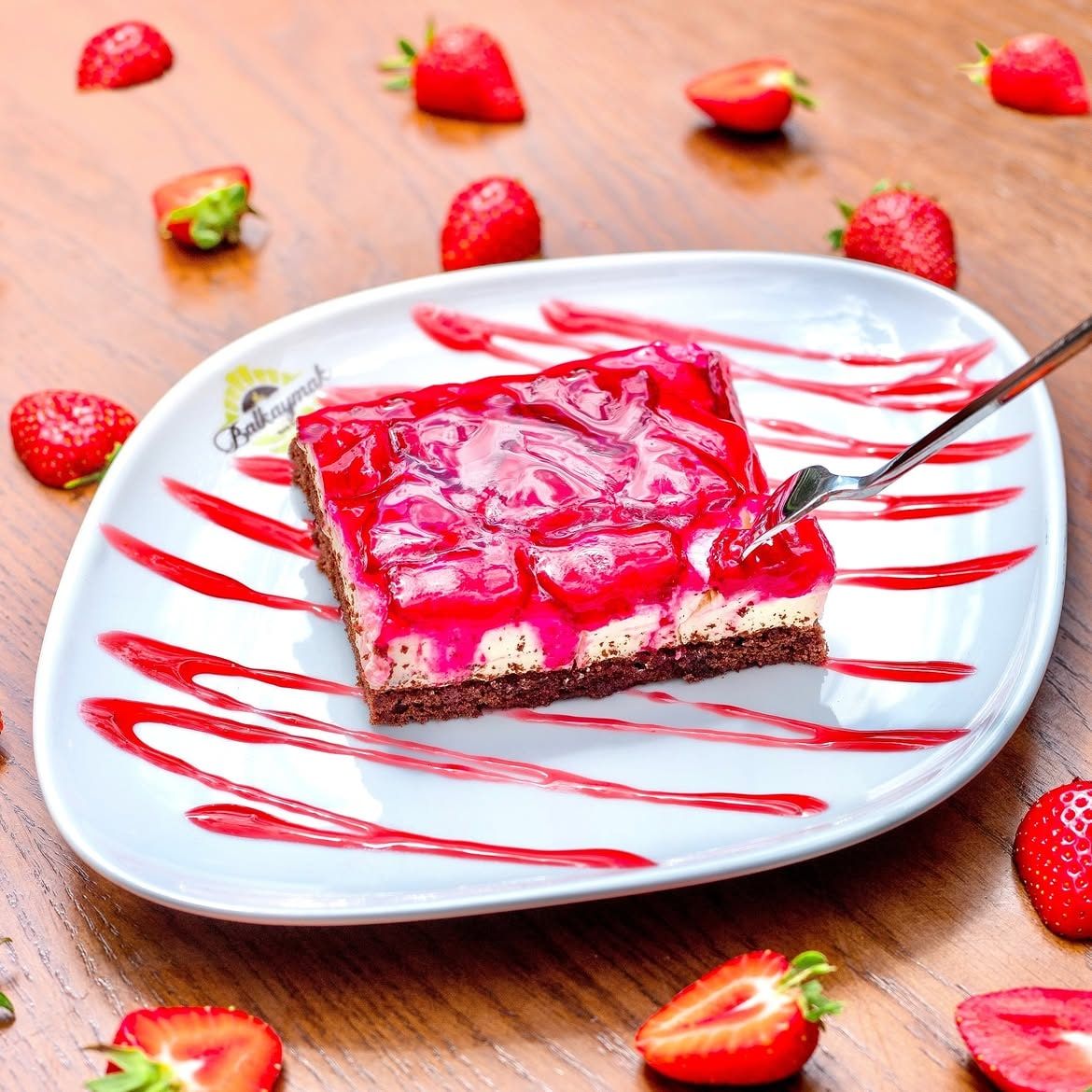 A strawberry cake slice on a Balkaymak plate